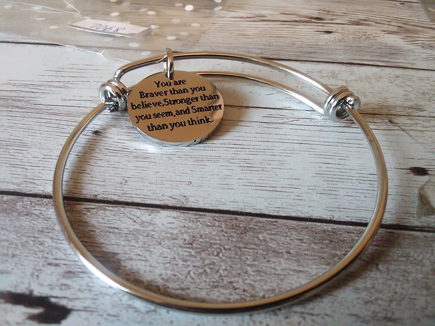 Brave and strong inscription on wire bracelet
