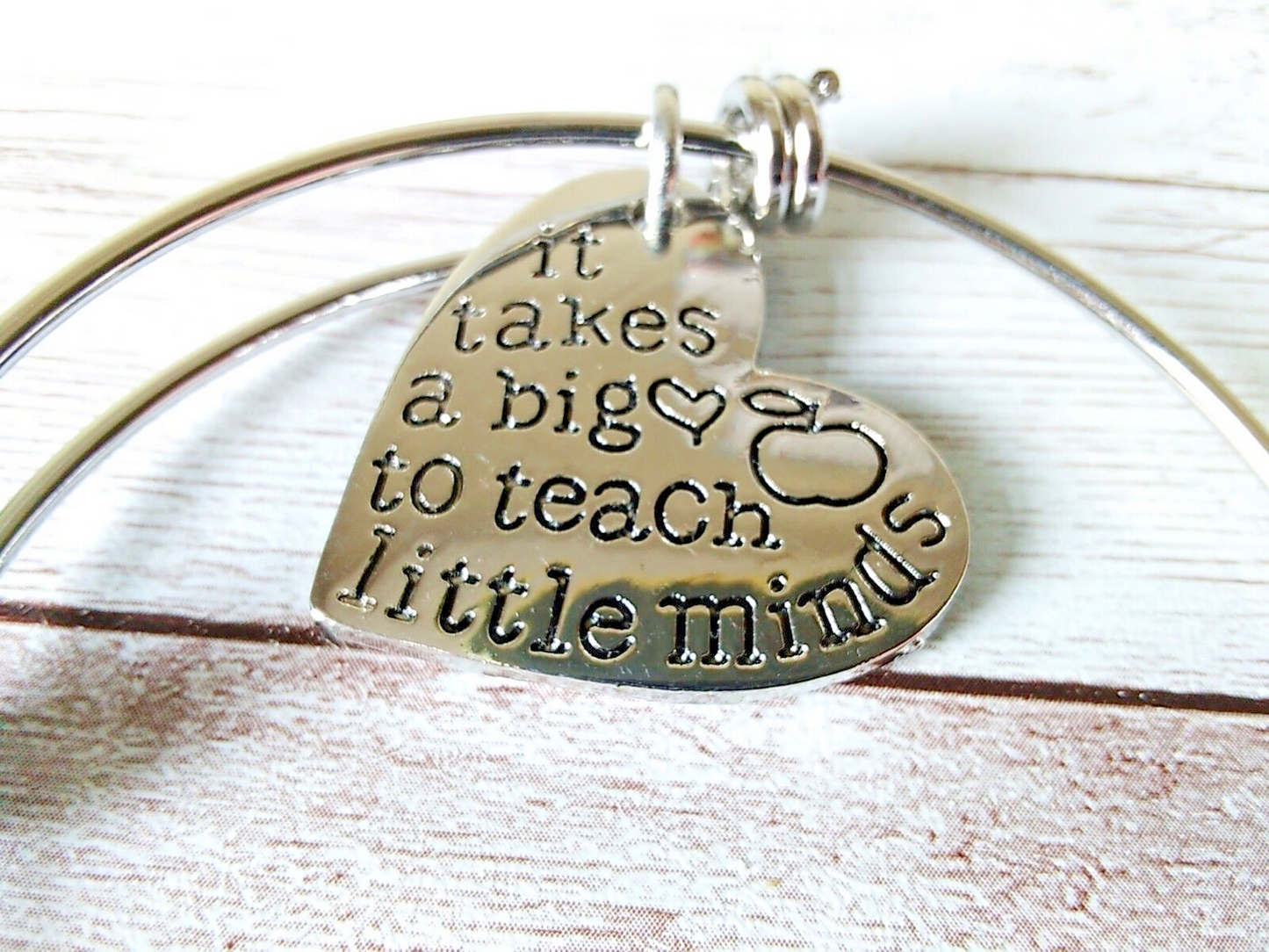 Close-up of charms on teacher appreciation bracelet