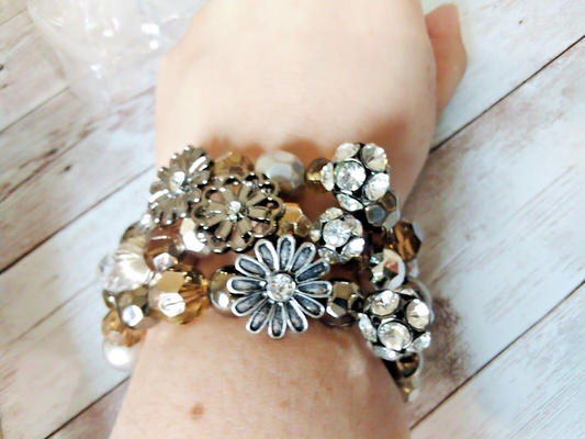 Close-up of silver, gray, and champagne beaded bracelet trio