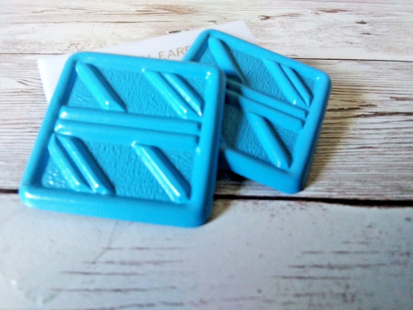 Detail of retro bright blue square earrings