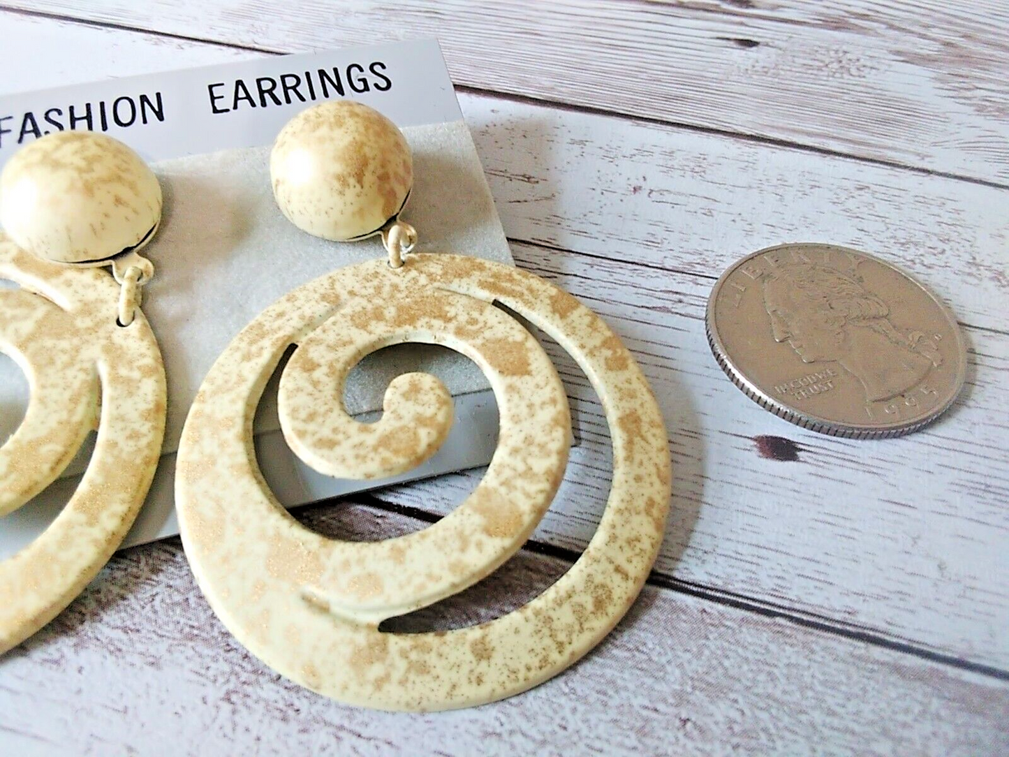 Cream-colored earrings with gold splatter from the 1980s