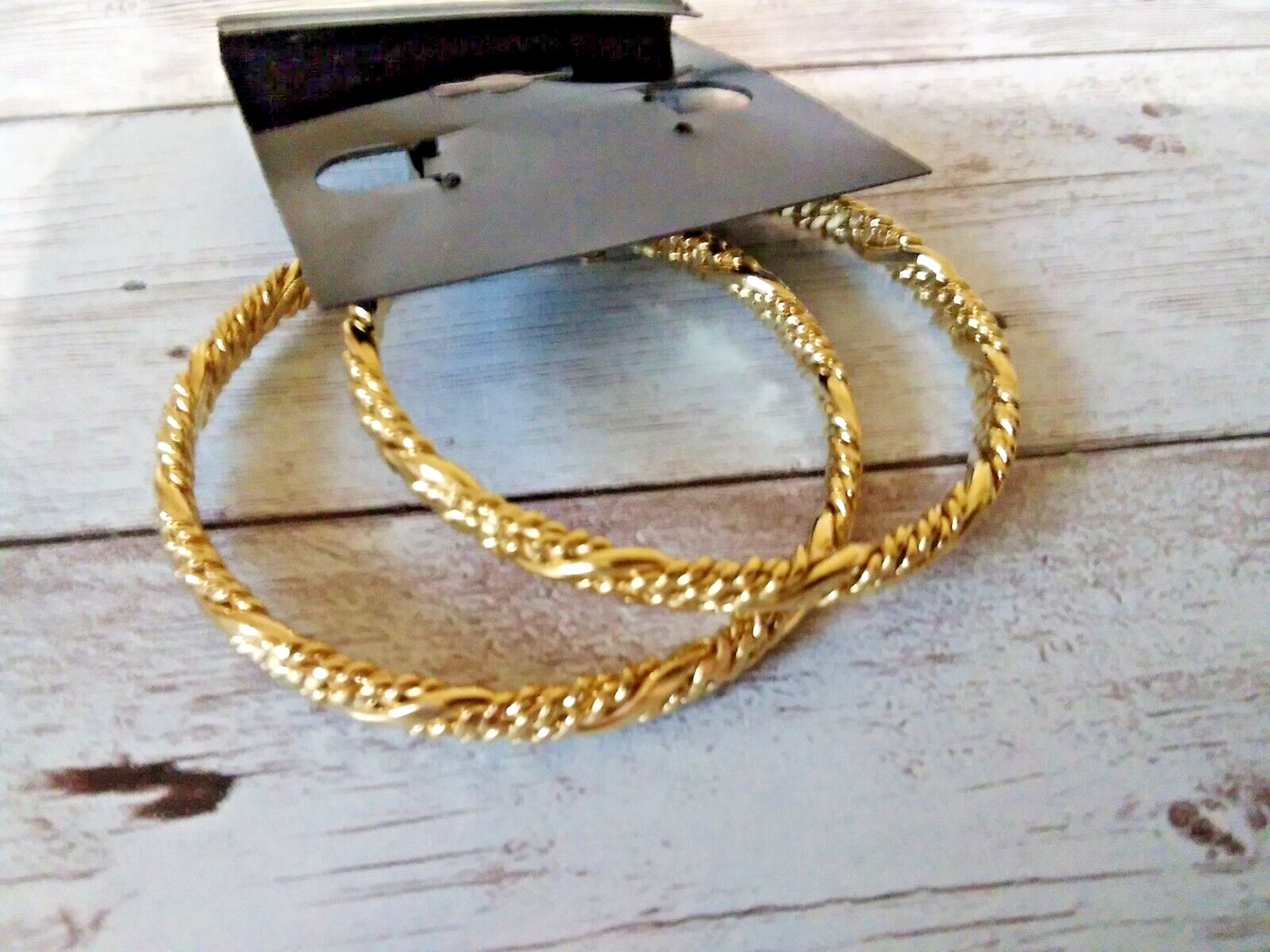 Gold-plated earrings with elegant twisted rope pattern - back of earring card which is blank