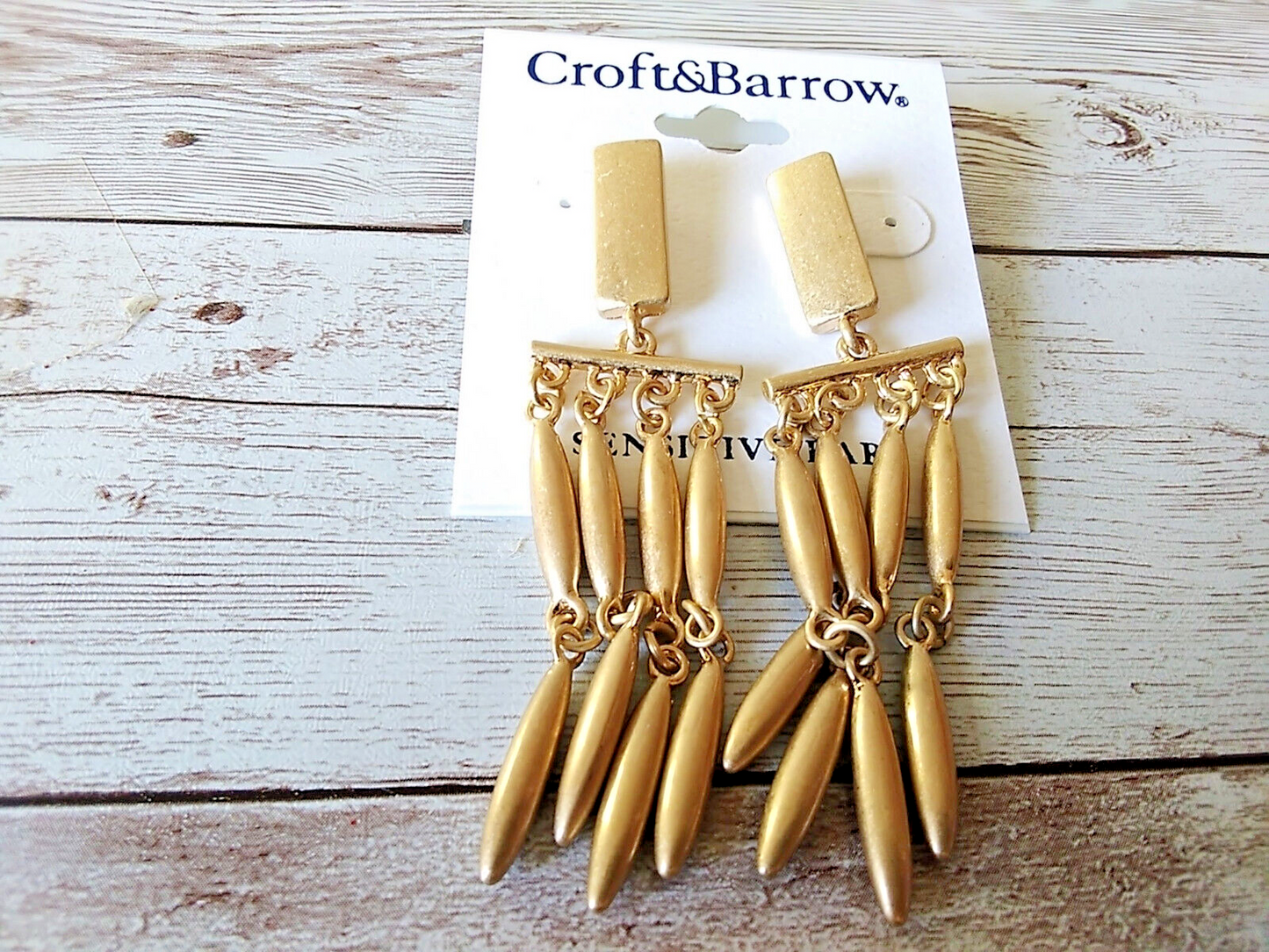Close-up of Croft & Barrow chandelier earrings with gold tone and cascading dangles