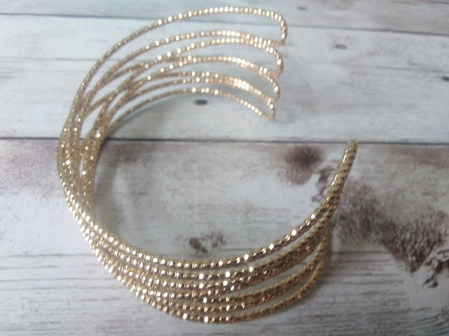 Gold tone cuff bracelet with sophisticated style