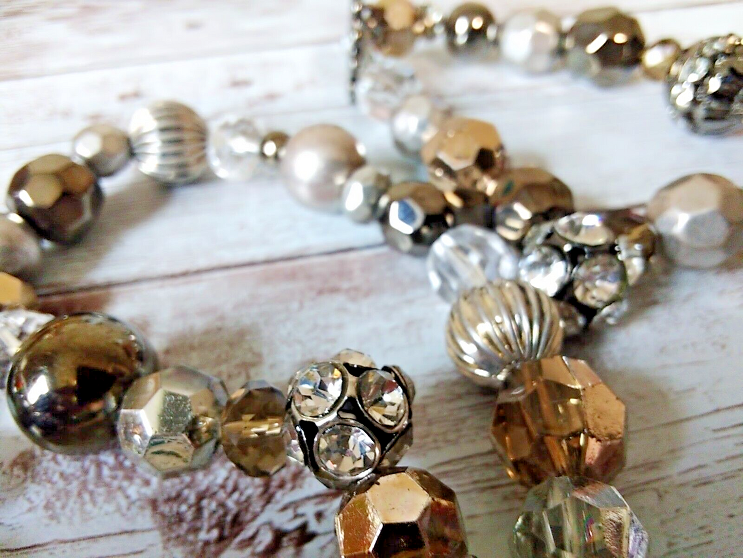 Detailed view of champagne and gray beaded flower bracelet