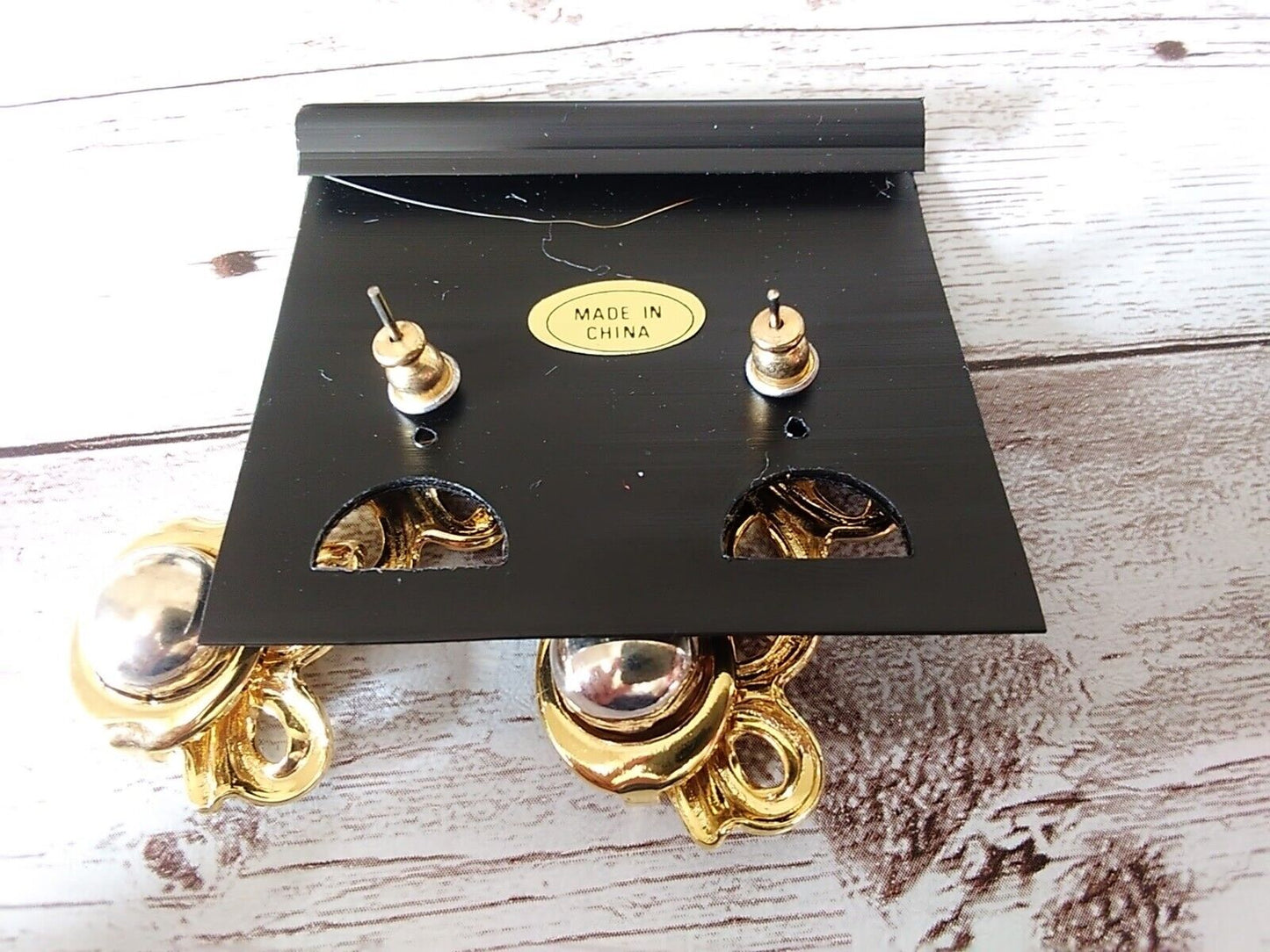Detailed shot of gold and silver tone earrings