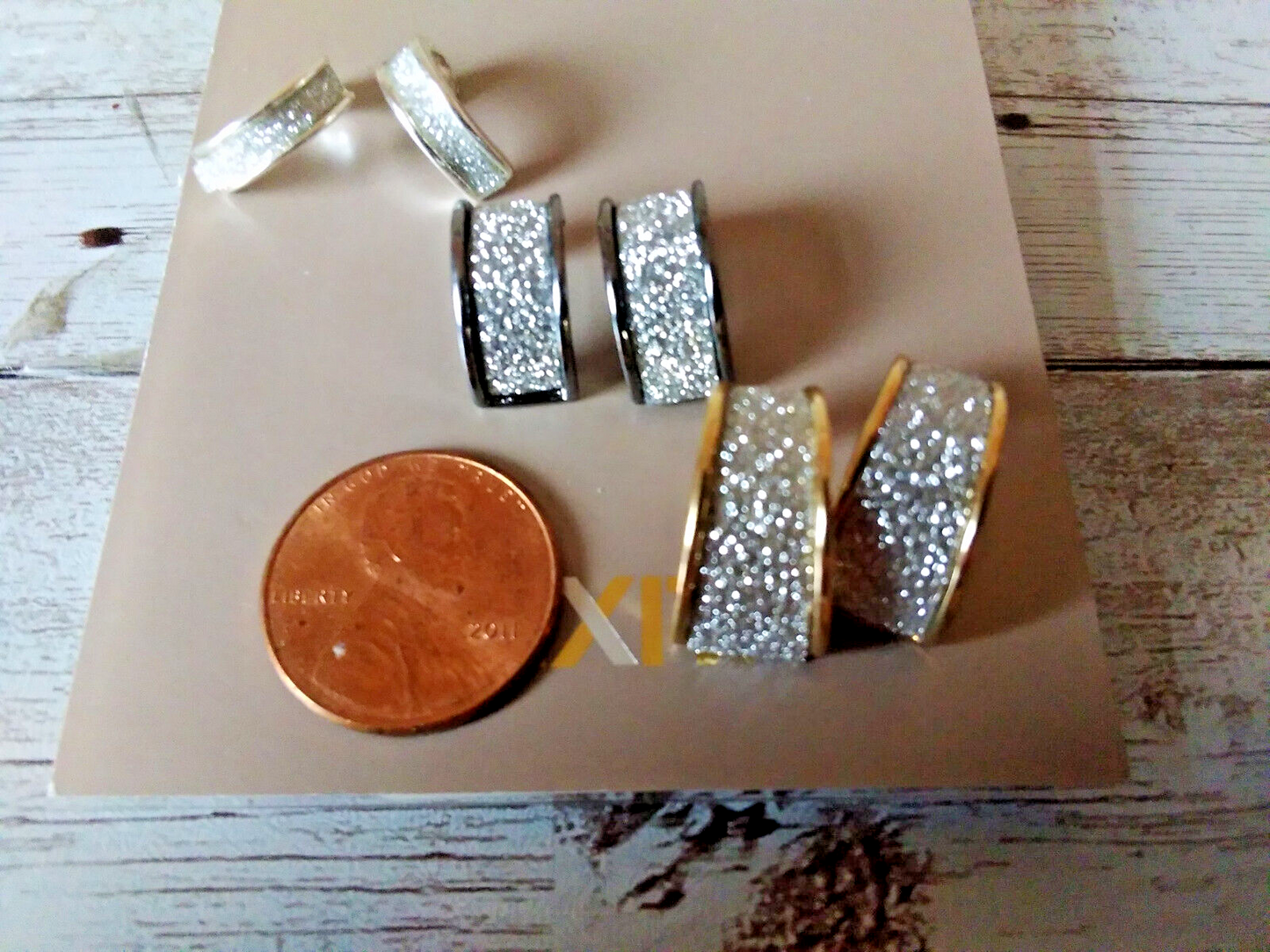 Small hoop earrings set with silver, gunmetal, and gold finishes