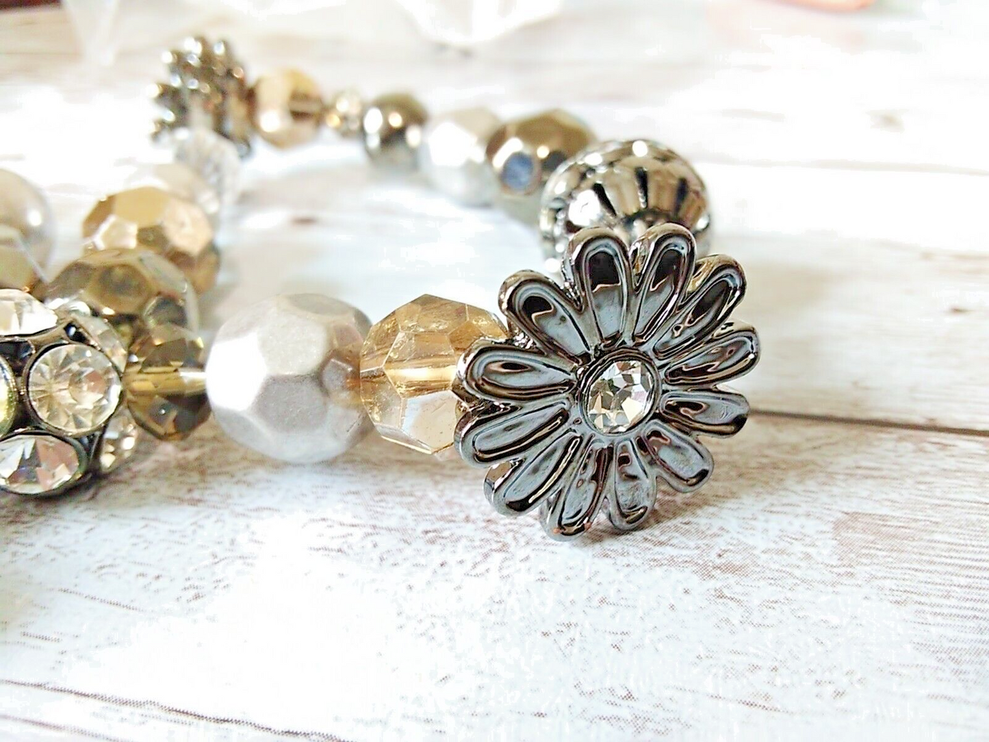 Close-up of silver, gray, and champagne beaded bracelet trio