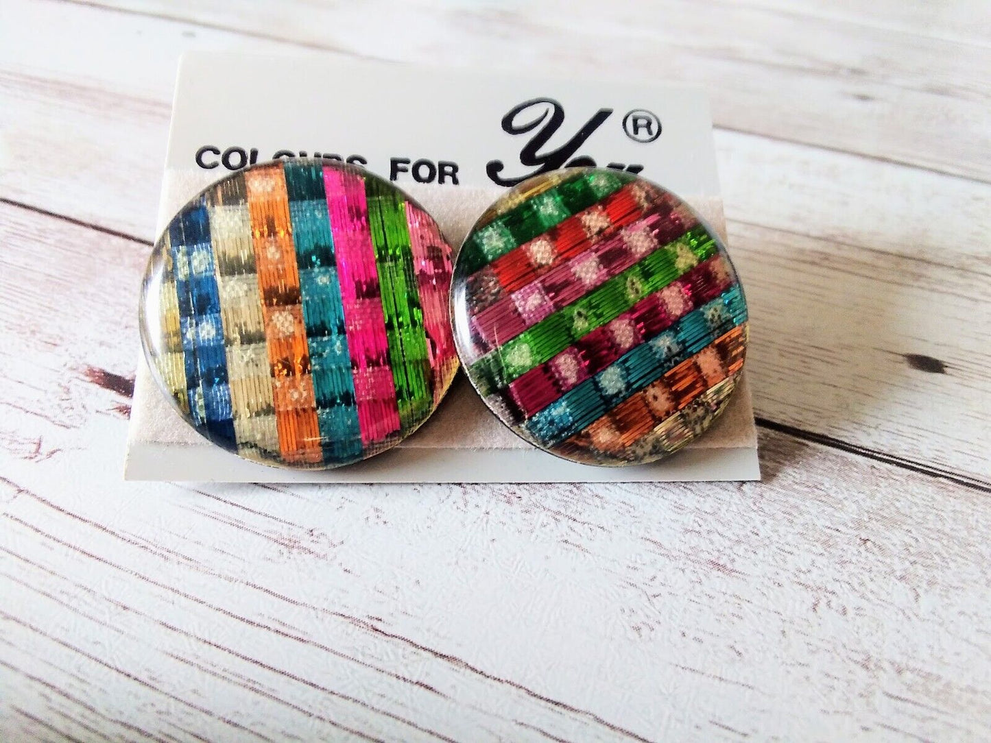Close-up of 1980s button earrings with intricate basketweave pattern