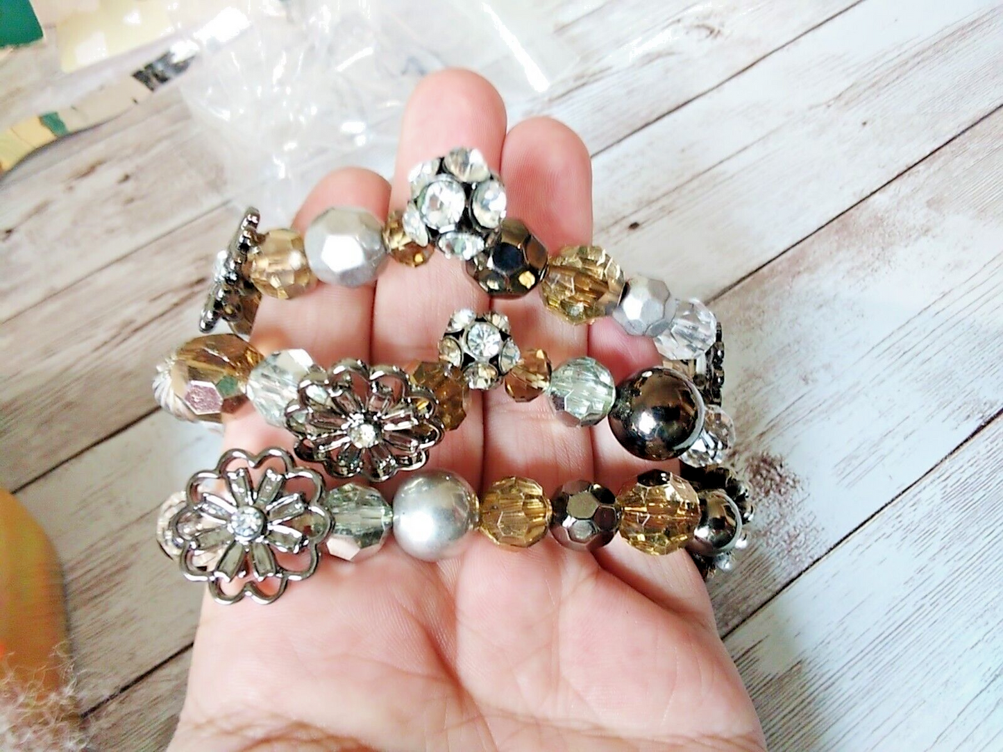 Stack of silver, gray, and champagne beaded bracelets