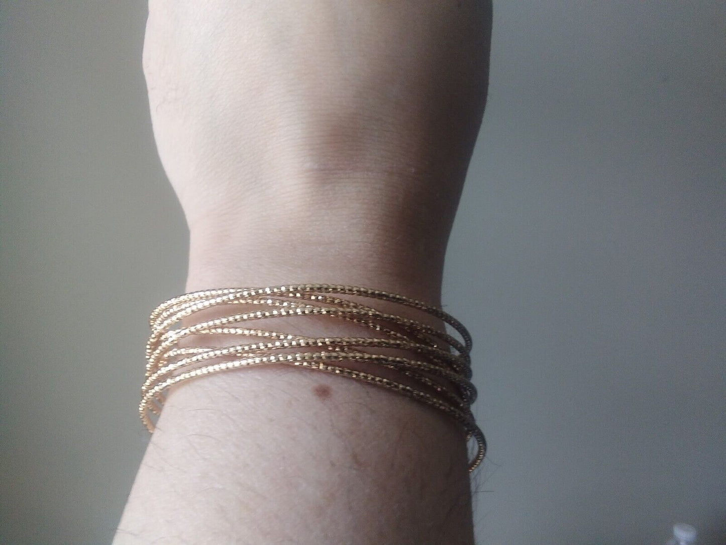 Adjustable gold cuff bracelet with winged details