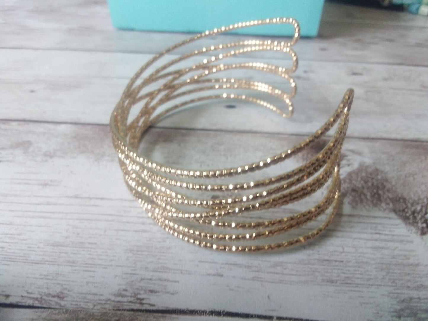 Winged design gold cuff bracelet