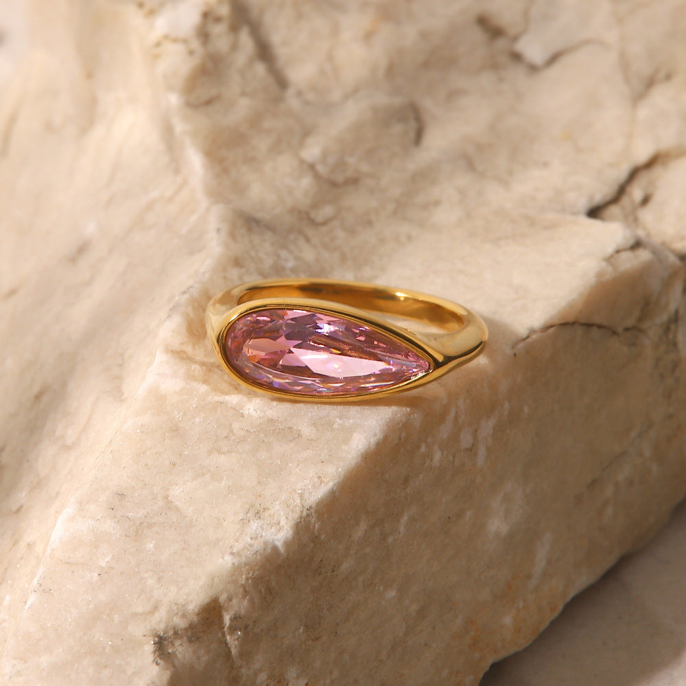 Close-up of the oval pink cubic zirconia set in 18K gold ring