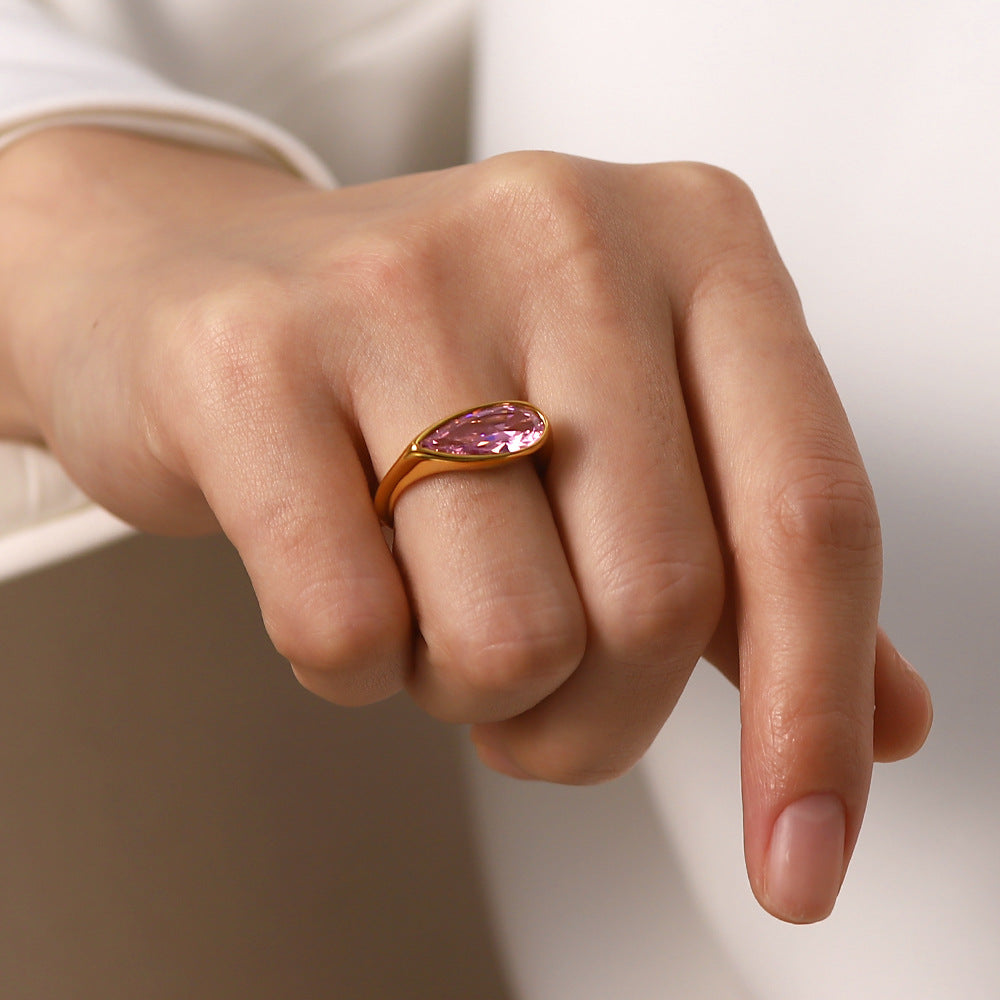 18K gold ring with pink cubic zirconia styled on a model's hand