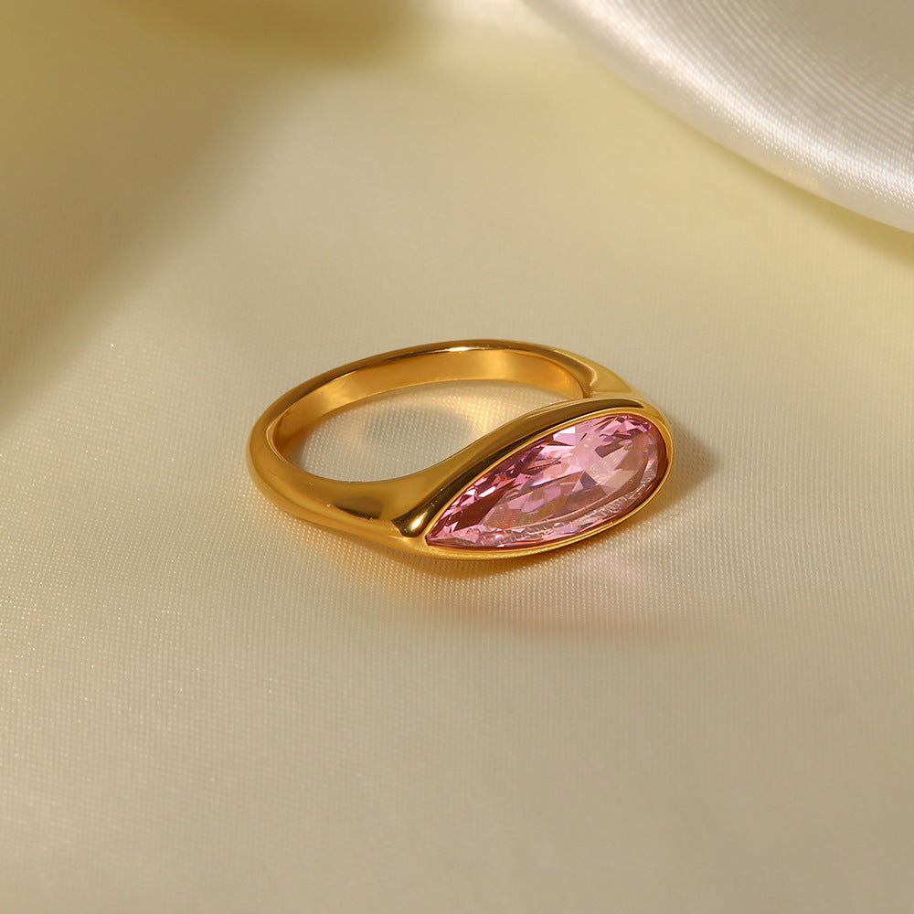 Side view of 18K gold ring showing smooth band and pink cubic zirconia