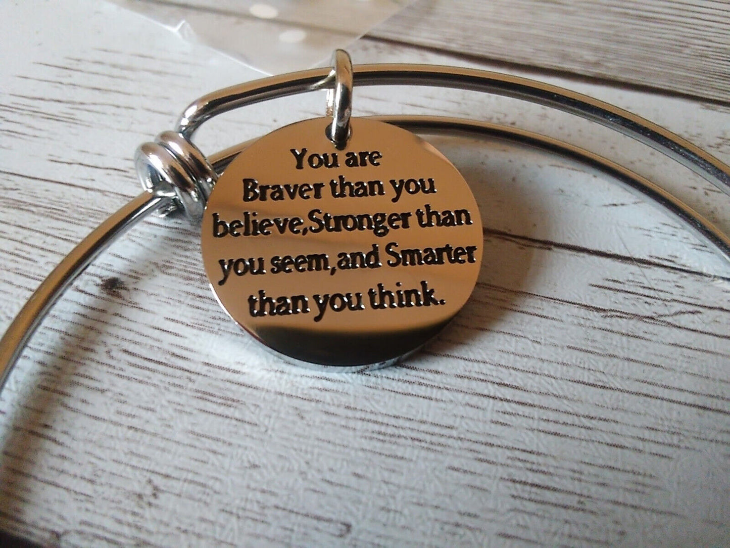 Close-up of "You Are Braver Than You Believe" bracelet