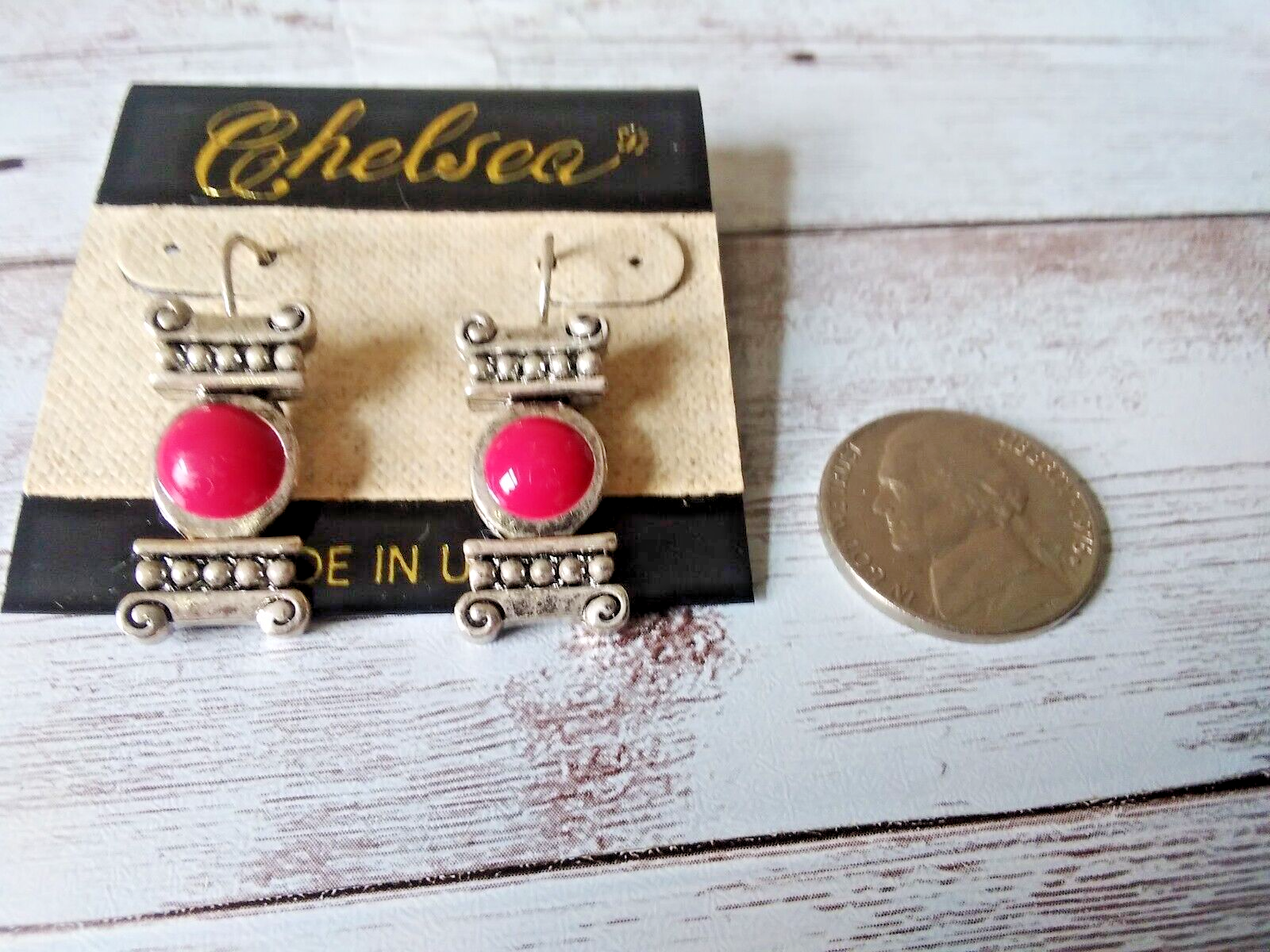 Close-up of hot pink column earrings from the 1980s with silver plating