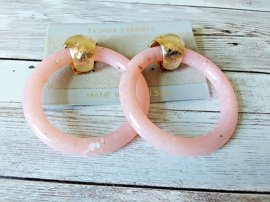 Gold-tone drop earrings with vibrant pink loops