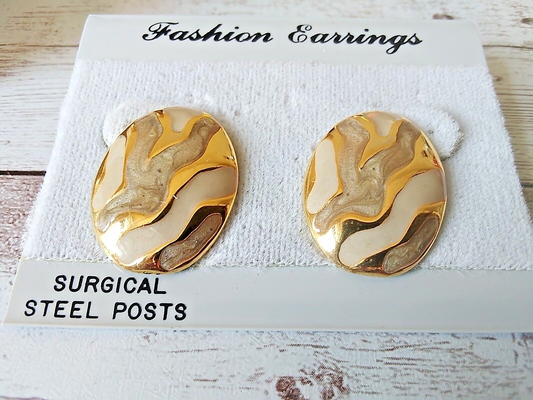 Close-up of gold plated enamel earrings from 1980s