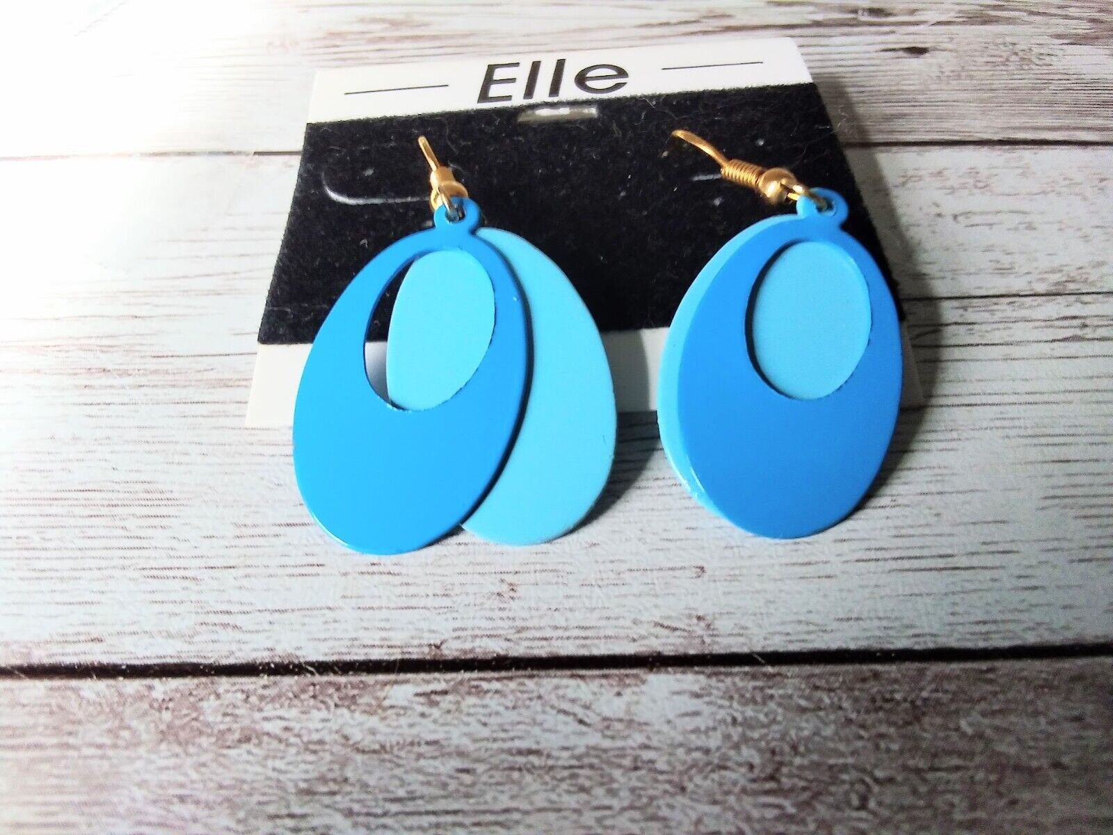 Close-up of 1980s blue two-layered dangle earrings by ELLE