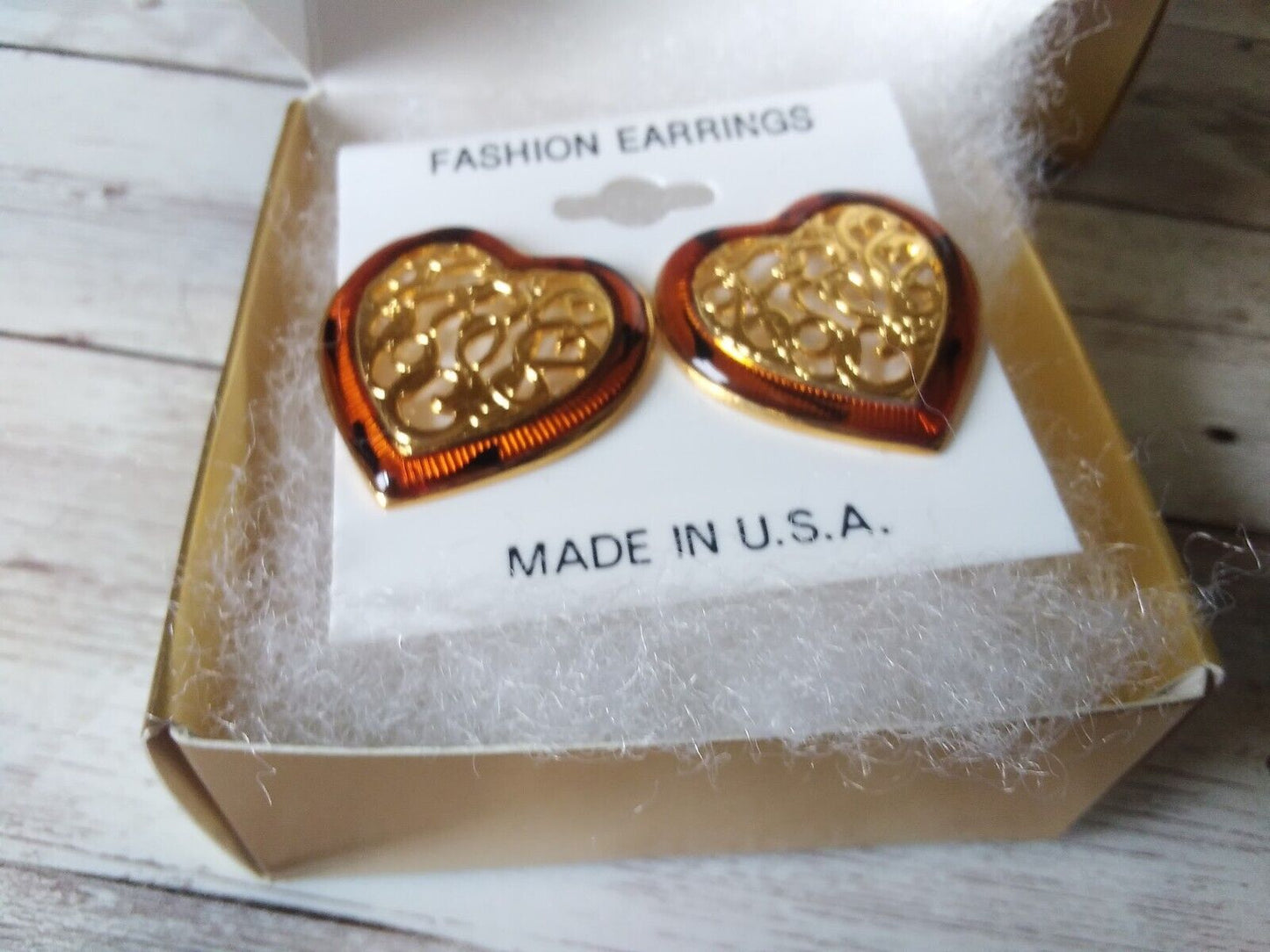 Close-up of the 1980s heart-shaped earrings with intricate design