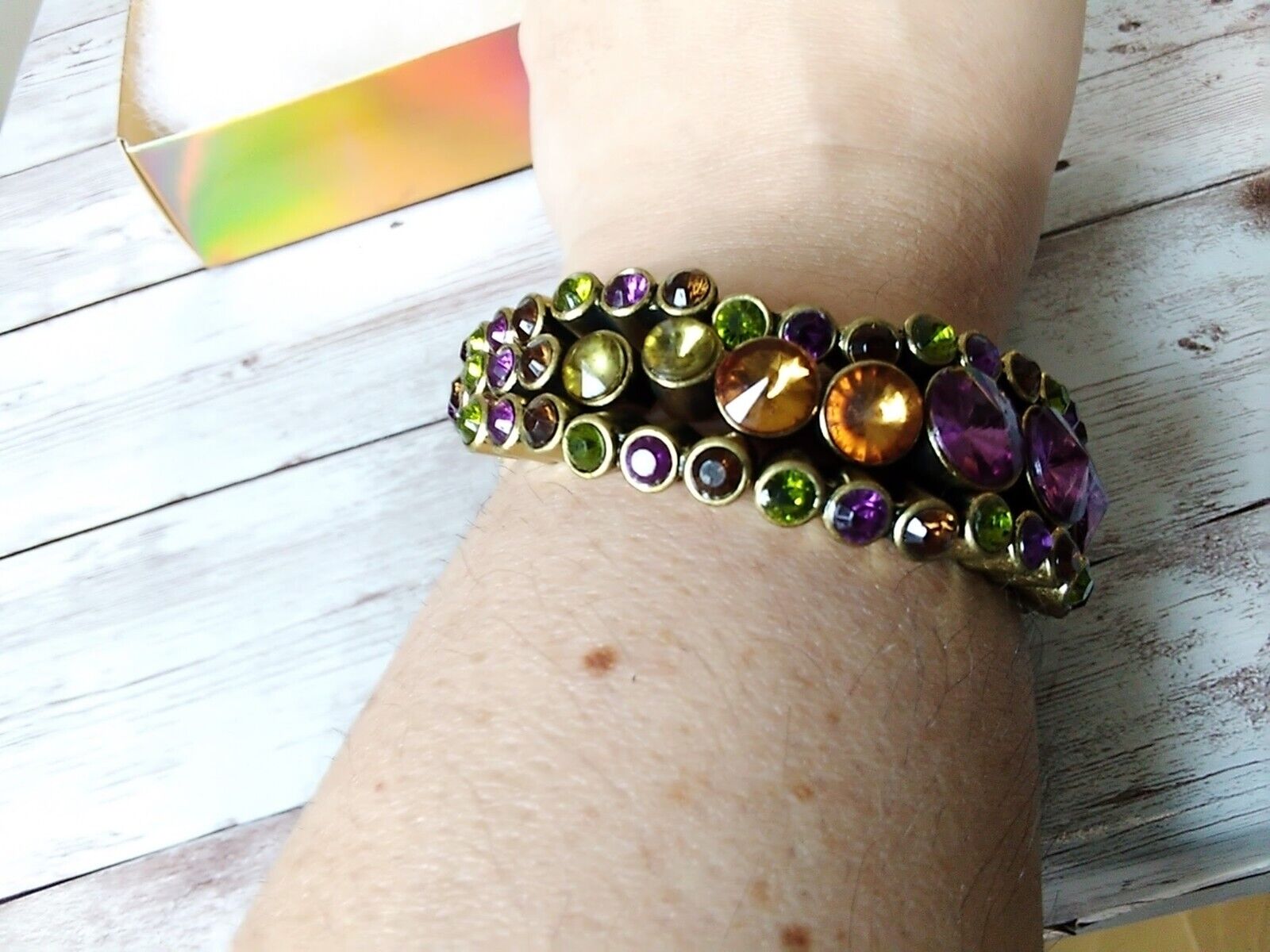 Bracelet shown on a wrist, showcasing its antique aesthetic and rhinestones