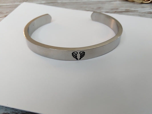 Close-up of In Memorium Stainless Steel Cuff Bracelet with engraved message