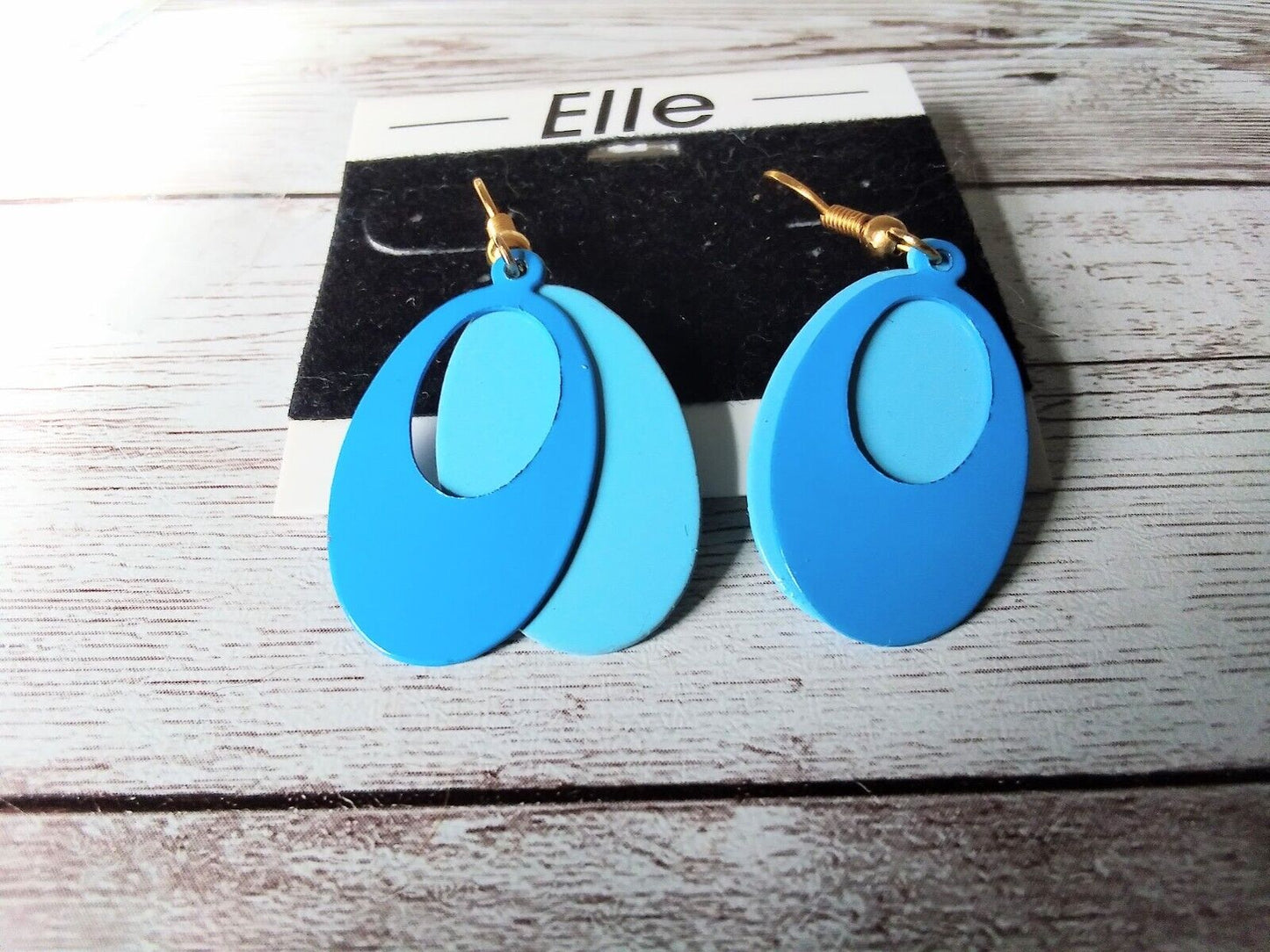 Display of 1980s blue two-layered earrings with surgical steel posts