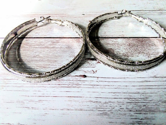 Extra-large silver hoop earrings with sparkling finish